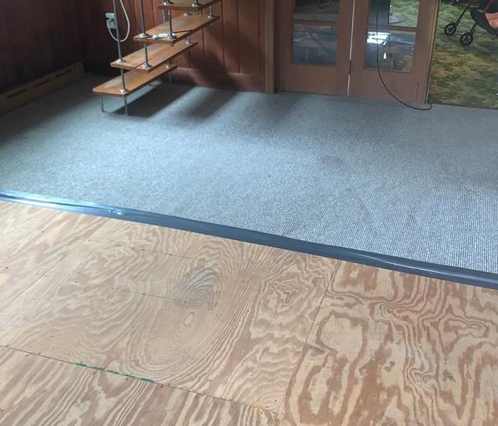 Sun room of residence following a water damage with exposed wood sub floor