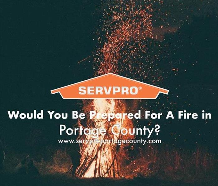 Orange SERVPRO house logo with a fire blazing on a black backdrop